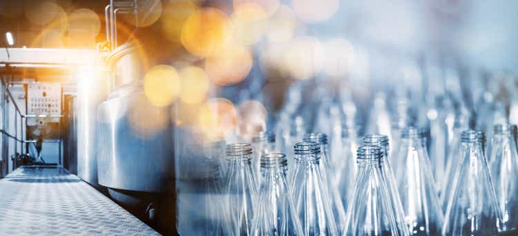 Conveyor belt, industrial production line, bottled juice in a beverage plant, selective focus.