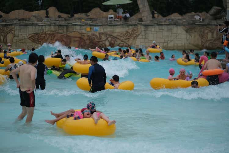 many Chinese people playing happily at water park