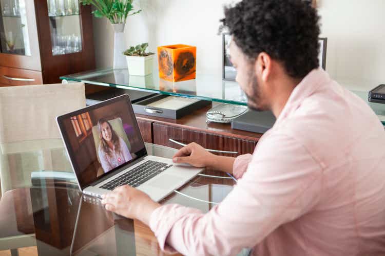 African American young man doing online psychotherapy at home