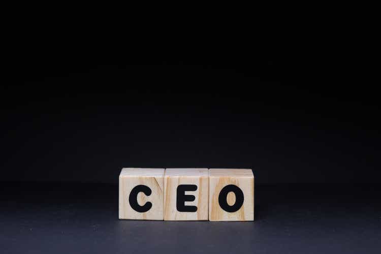 CEO word on wooden cubes on black background
