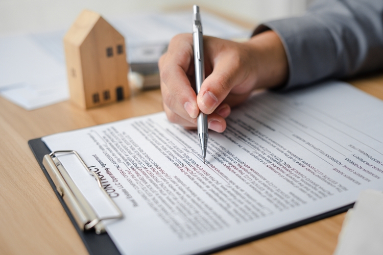 Clients sign real estate contracts through their brokerage agents to purchase a home a profitable investment for a safe residence with a promotion for a loan from a bank to buy property.