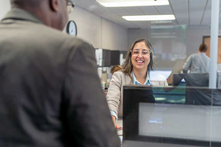 Cheerful customer service representative greeting customer