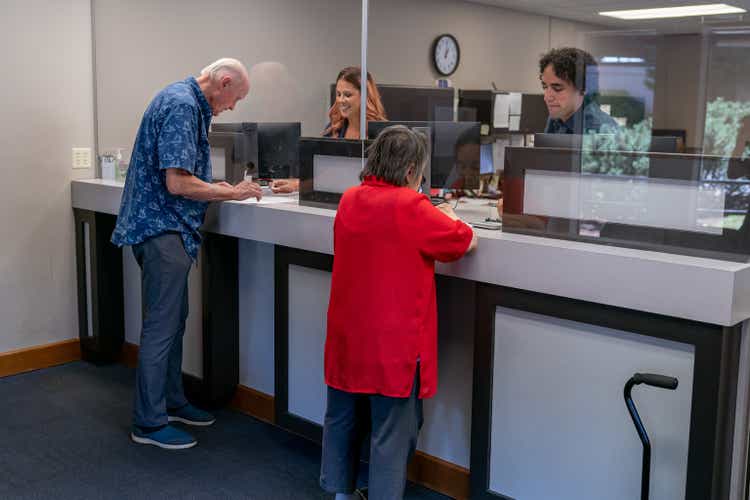 Senior man and woman at business reception desk