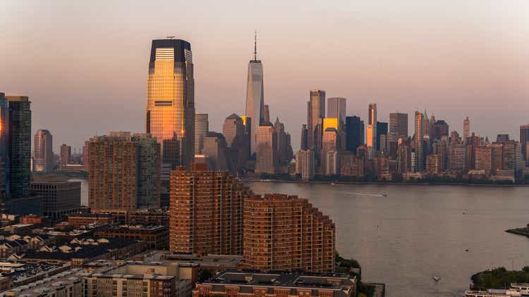 Paulus Hook in Jersey City with Goldman Sachs Tower and Lower Manhattan distant view, over the Hudson River at sunset.