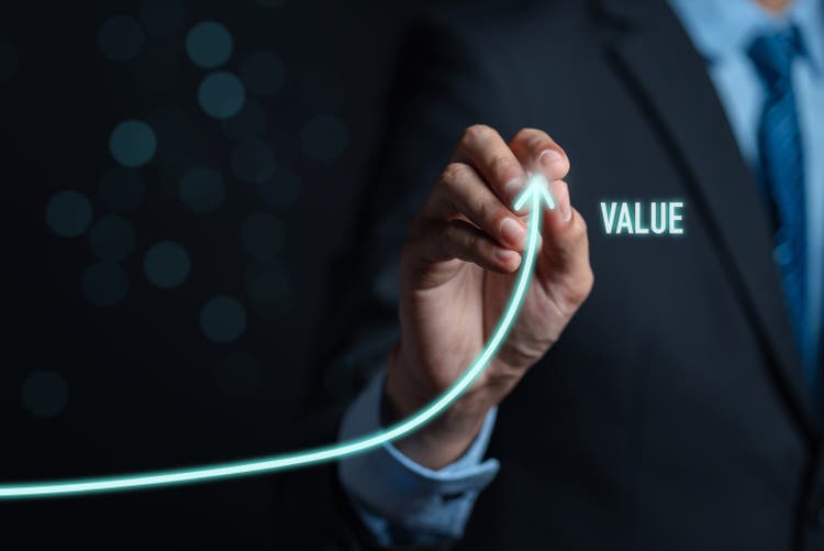 Businessman writing value of money target analyze sales data trading and showing a growing virtual screen of statistics, graph and chart stock market business growth, planing and strategy concept.