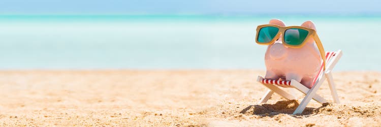 Piggy Bank With Wooden Sunglasses On The Deck Chair