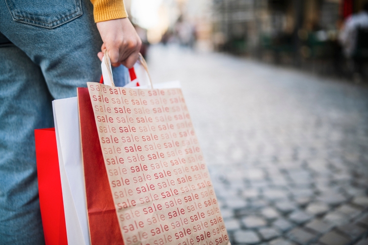 Woman with bags from shopping in sale.