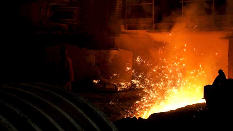 Iron and steel metallurgical plant, metallurgical production. Stock footage. Metal Melting process with many flying bright sparkles.