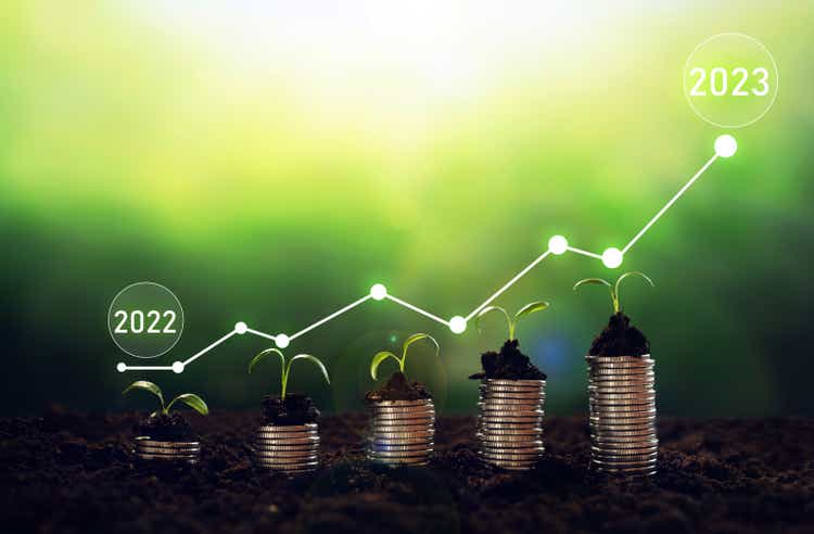Seedling are growing from soil with growth comparative year 2022 to 2023. New year 2023 development to success, strategy, plan, goals and vision. Business growth, profit development and success graph.