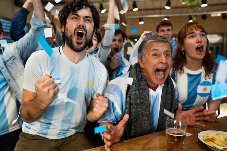 Argentine sports fans shouting and cheering for national team at sports bar