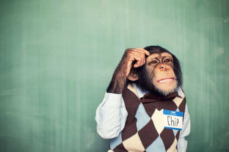 Young Chimpanzee Nerd Student Scratches Head