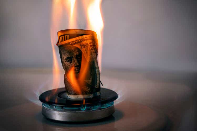 Increase in the price of gas. concept of problems in the USA economy. The dollar is burning on a gas stove. The sale of gas. Expensive gas supply. dollar crisis. Rejection of the dollar.