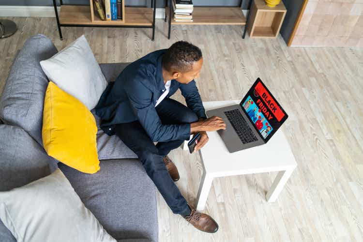 Man shopping on Black Friday with a laptop compute