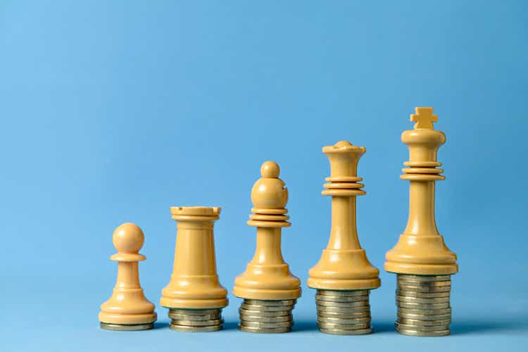 Chess pieces on stacked coins.