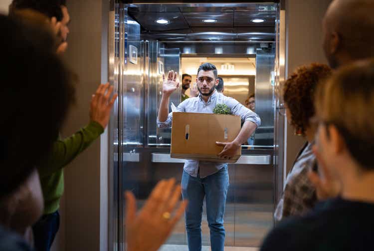 Man being fired at his job and leaving the office