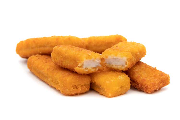 Delicious and crispy fried fish sticks (fish fingers) on a white background.