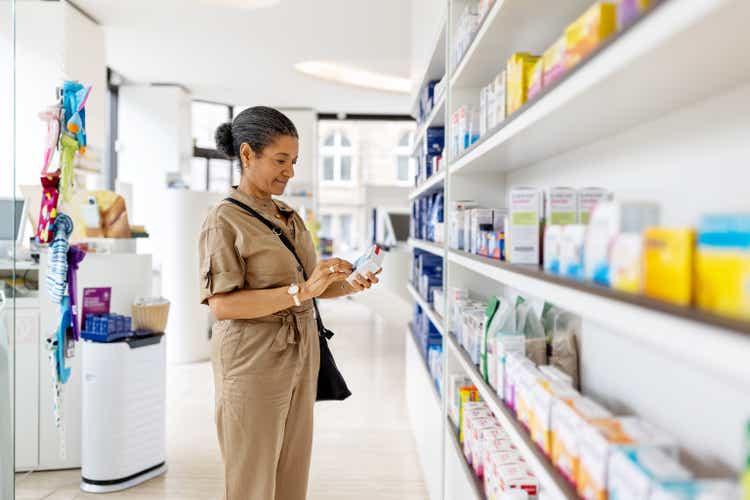 Senior woman buying medicine at drugstore