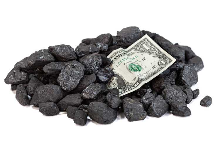 dollar banknote strewn with coal