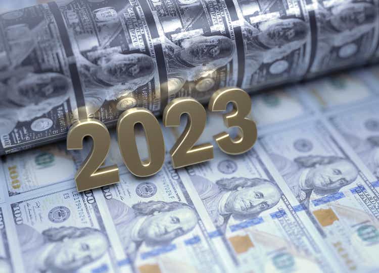 Gold Colored 2023 Sitting Over 100 American Dollar Bills - Money Printing and Inflation Concept