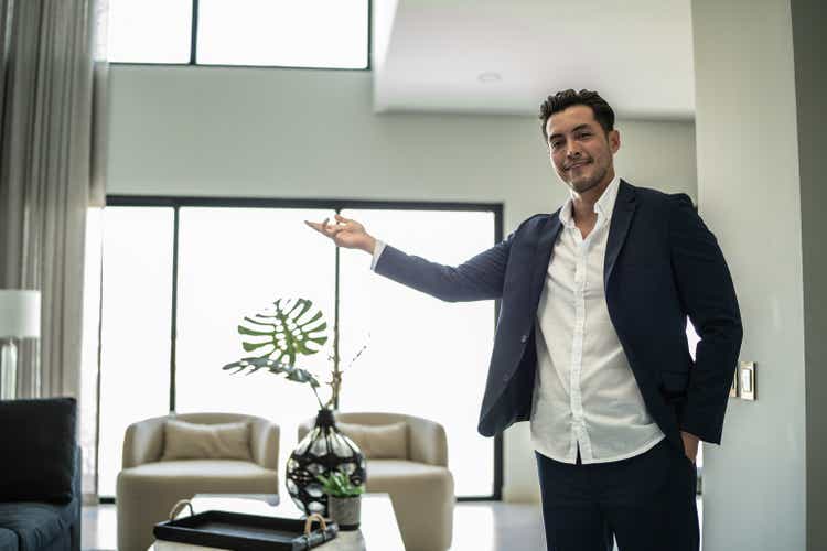 Portrait of a real estate agent showing the home