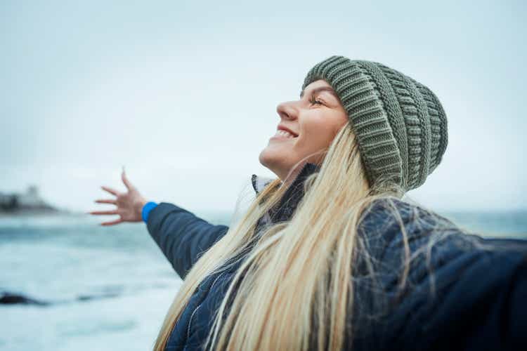 A woman finding success and freedom on Canada's beaches, oceans and oceans with climate goals, sustainability goals and an environmental mindset.Happy smile by water waves, nature volunteer, marine biologist