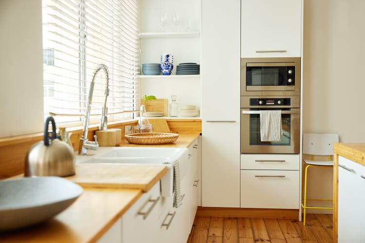 Sink with faucet on kitchen counter by window
