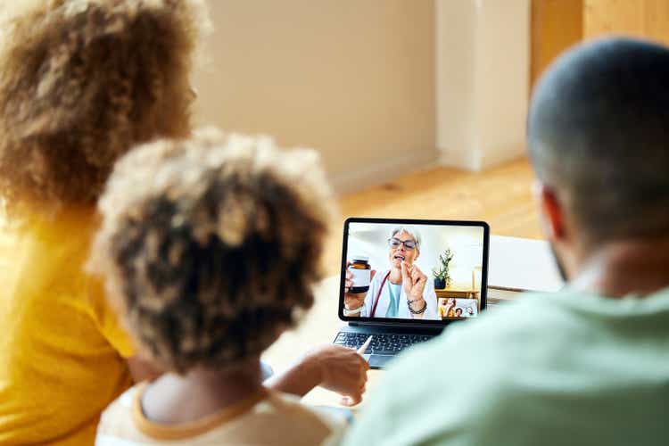 Doctor advising family through video call at home