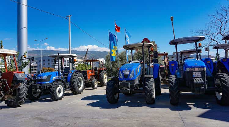 New Holland Agriculture logo on tractor in the dealership store against a blue sky at Araclar, Turkey