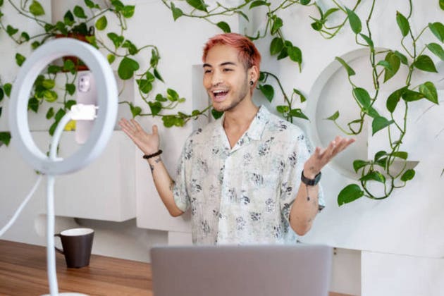 Social media influencer making a video blog for his channel at studio