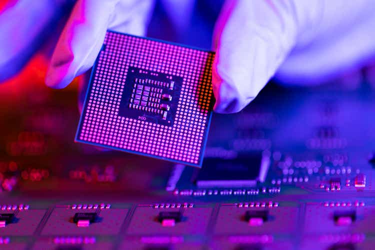 Laboratory technician holds a powerful processor in his hands