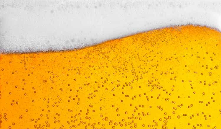 Pouring beer with bubbles for background and wave shape texture foam