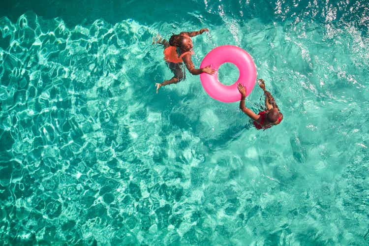 Aerial view point of mother and daughter swimming together.