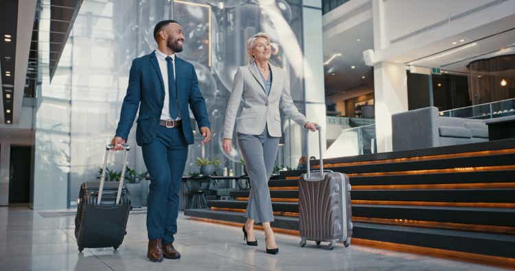 Traveling, suitcase or business people with manager at airport for meeting, vacation or international work trip. Employees, workers or business men and women walk to the plane, restaurant or workshop.