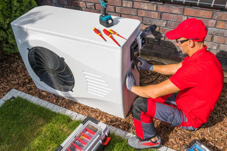 Technician Repairing Heat Pump Unit