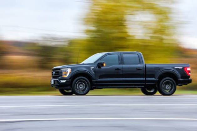 Black Ford F150 on a road against blur background