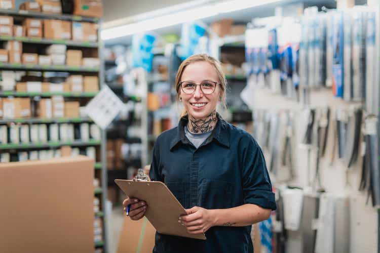 merchandiser checking products availibility for car repair