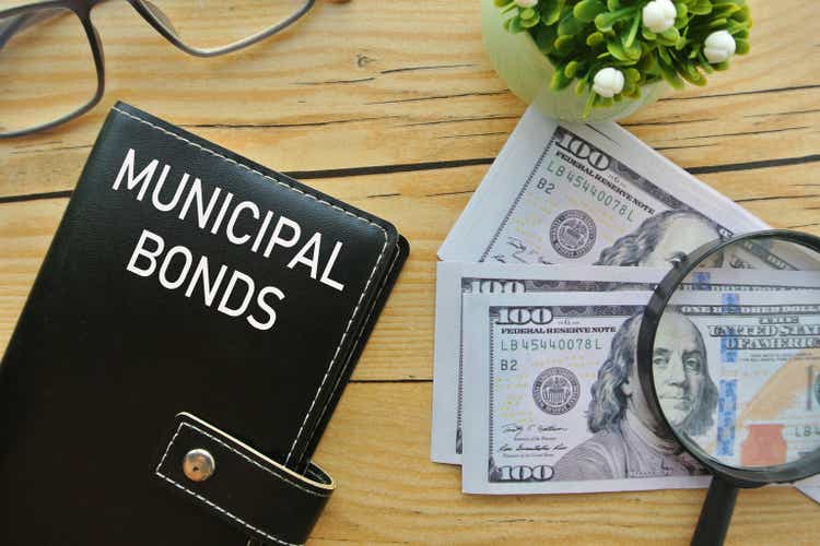 Word Municipal bond on note book, inscription with America usd fake money.
