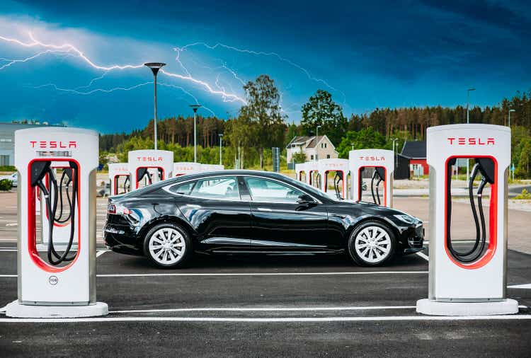 Black Color Tesla Model S 100d Car Parked At Charging Station. The Tesla Model S Is A Full-sized All-electric Five-door, Luxury Liftback, Produced By Tesla Inc.