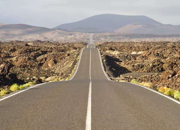 Road leading into the distance in volcanic landscape