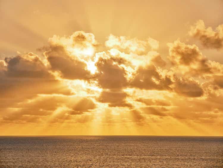 Vivid orange clouds over the sea at sunset