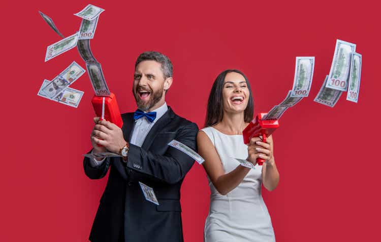 millionaire couple with money gun won jackpot. couple millionaire hold money gun. casino jackpot.