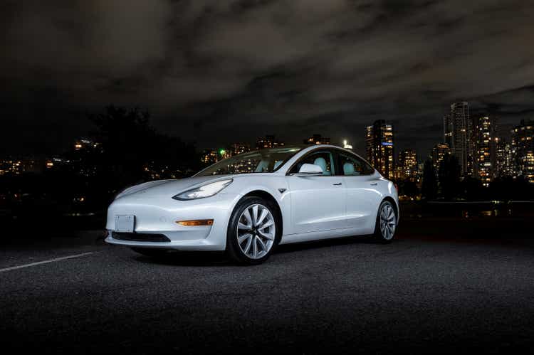 Tesla Model 3 at night Vancouver City by the public boat ramp