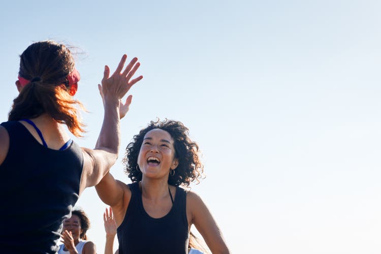 The women high-five and rejoice with each other.