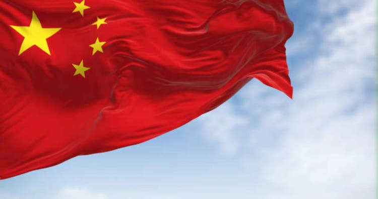 Close-up view of the China national flag waving on a clear day