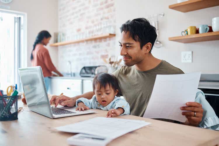 Man, baby or laptop finance in house or home kitchen and insurance paper, investment documents or fintech accounting software. Happy smile, asian father and down syndrome boy, son and child with tech