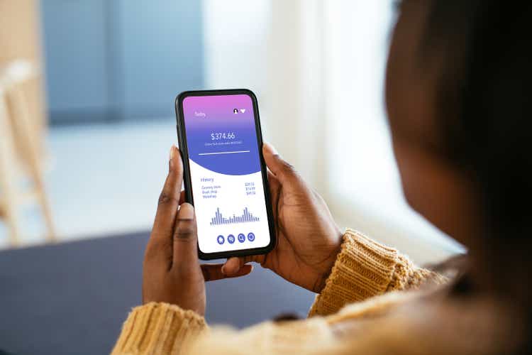 African businesswoman using mobile app on smart phone for finance and online banking