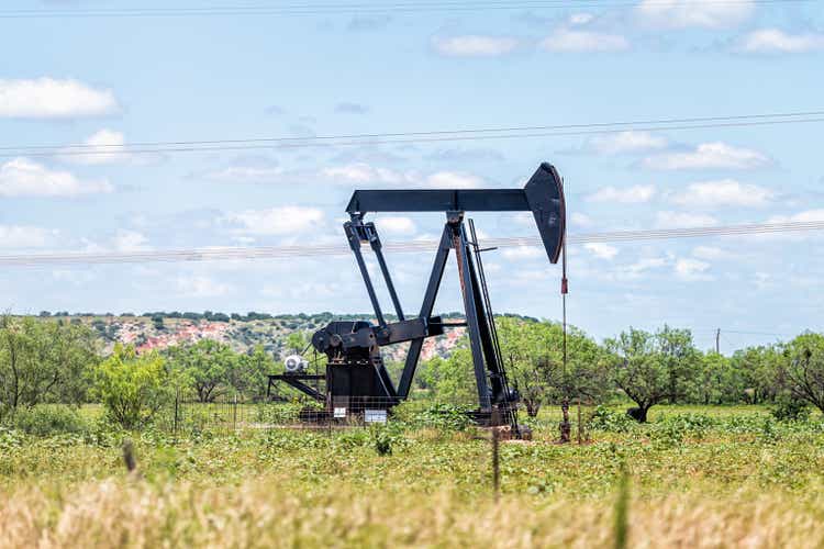 Sweetwater, Texas oil pumpjack on Oilfields in prairies with metal machine in field on sunny summer day with blue sky and nobody in landscape
