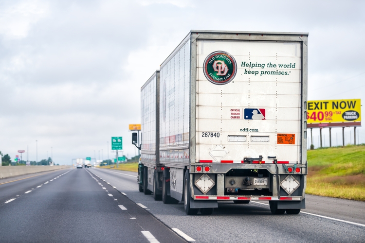 Old Dominion freight line truck with doubles tandem trailer hauling shipment on interstate highway in Georgia