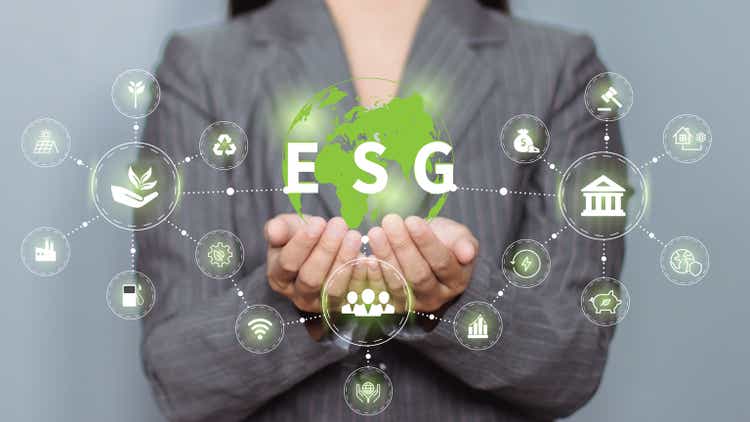 Hand holding a green globe in the concept of nature about management esg, sustainability, ecology and renewable energy for save the world environmental and conservation