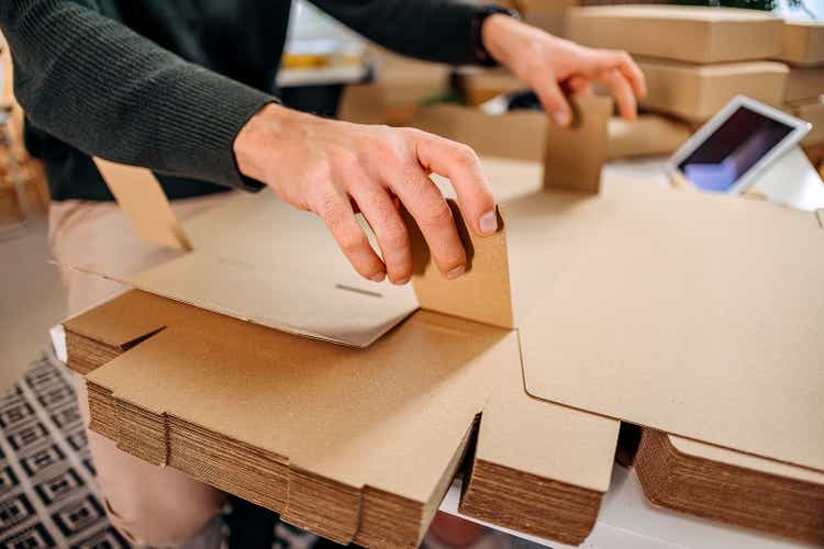 Man folds a cardboard box